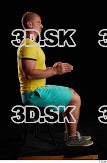 Sitting reference of whole yellow shirt turquoise shorts brown shoes…